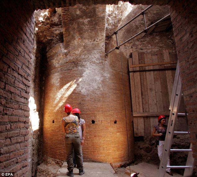 Archaeologists examine the 4-metre thick pillar that supported the hall